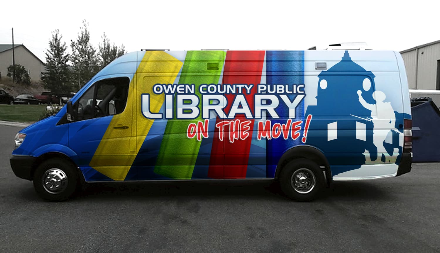 The Owen County Public Library Bookmobile — a Mercedes-Benz Sprinter van wrapped in a multicolored design with the library logo on the side and the slogan "On the Move!"
