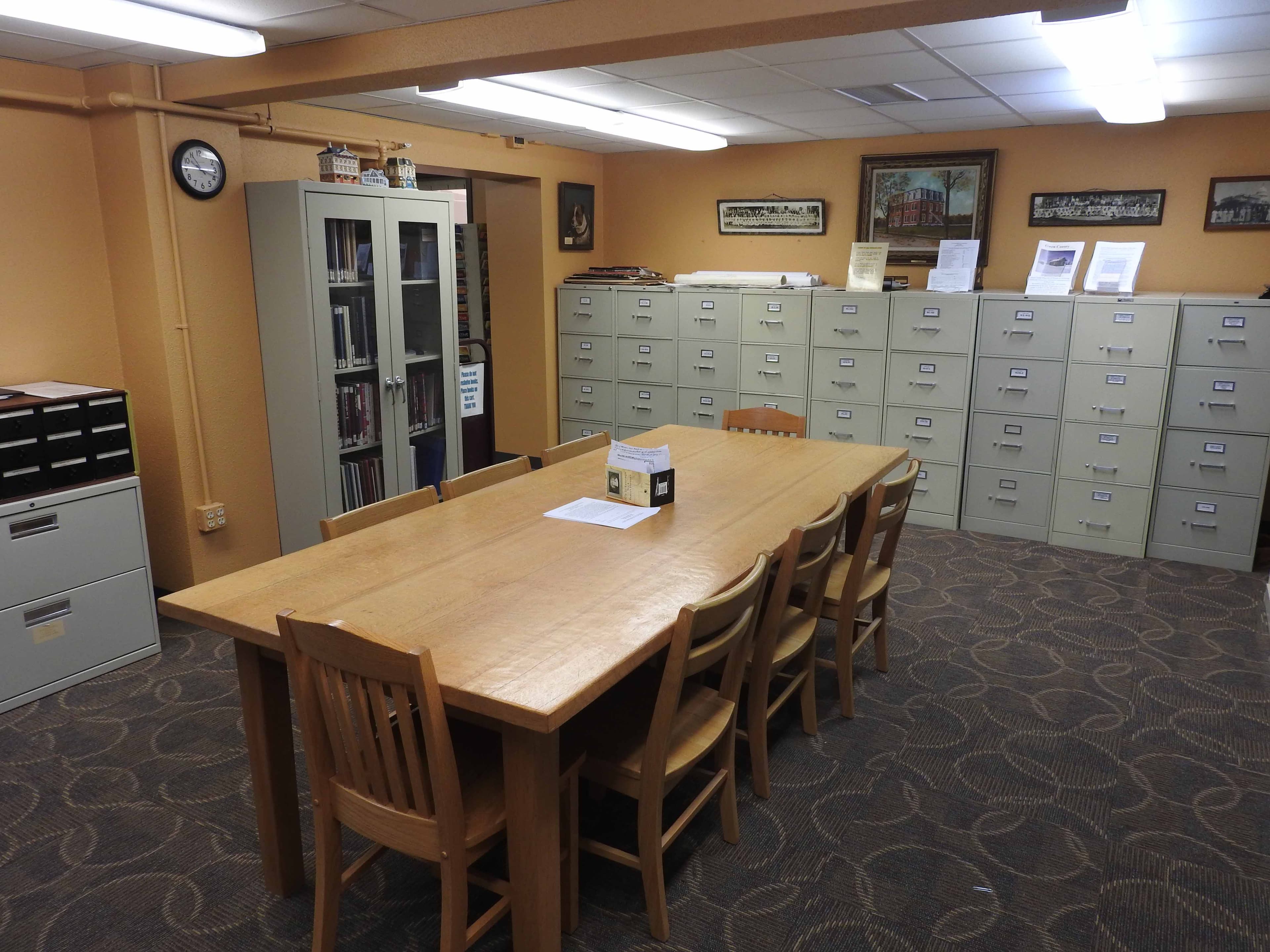 Microfilm scanner station in the genealogy department, with viewing screen and reels.